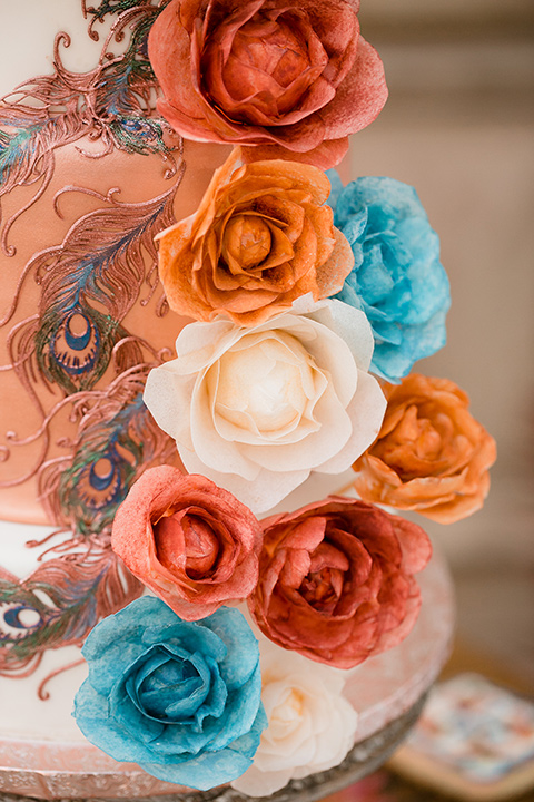 white cake with blue and orange floral details