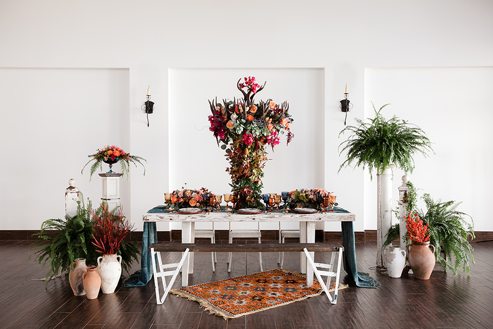  table with white linens and gold flatware