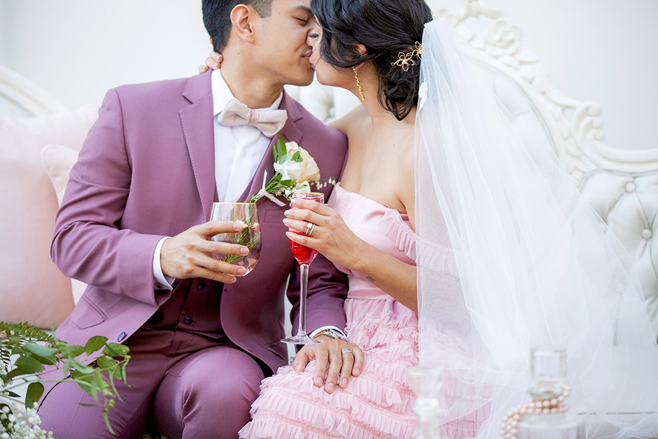  bride in a pink ballgown with ruffles and strapless neckline