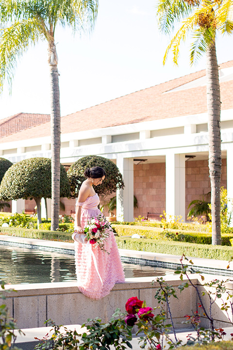  bride in a pink gown with ruffles