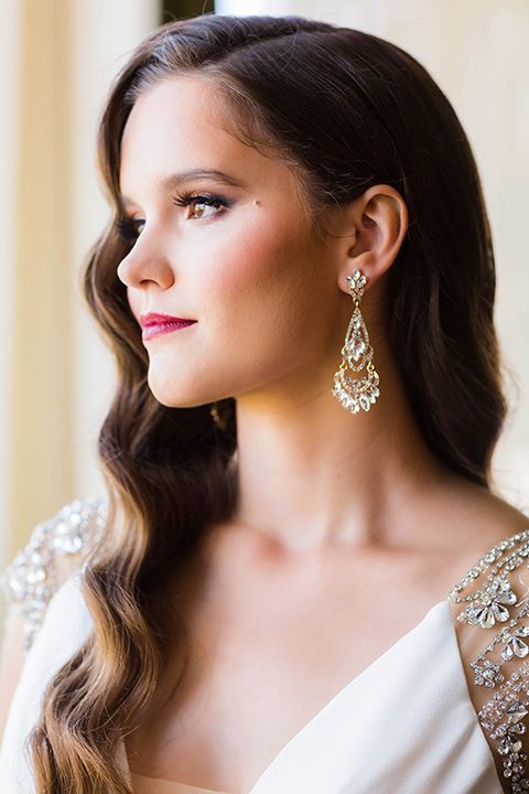 bride with a soft fingerwave hair style with delicate makeup and gold earrings