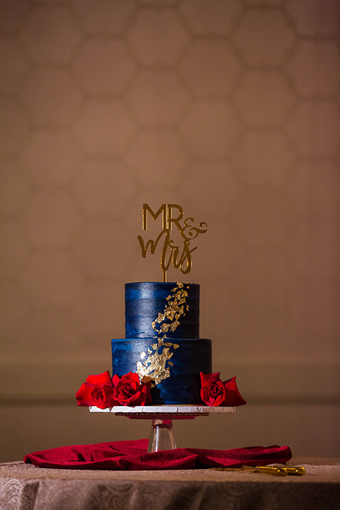 navy cake with gold and red decor