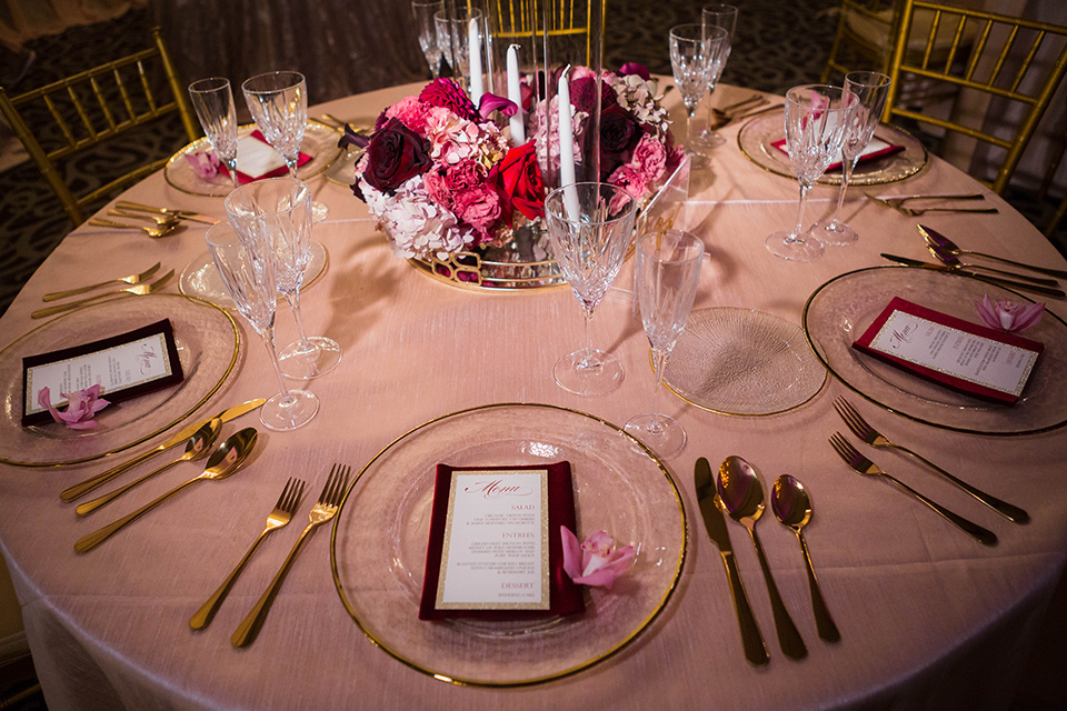  sweetheart table with rose gold linens and pink and purple flowers and gold Mr. and Mrs. lettering and gold flatware 