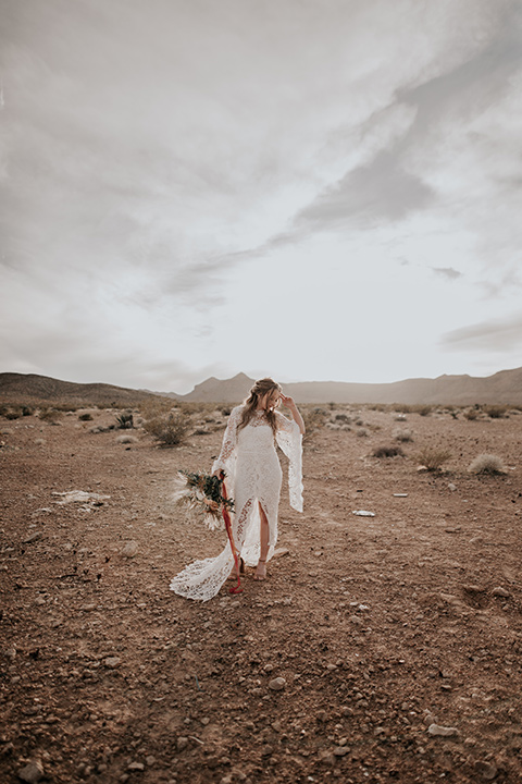  bride in a bohemian white gown with lace detailing and long sleeves