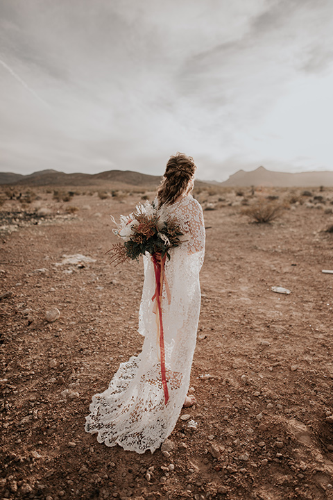  bride in a bohemian white gown with lace detailing and long sleeves