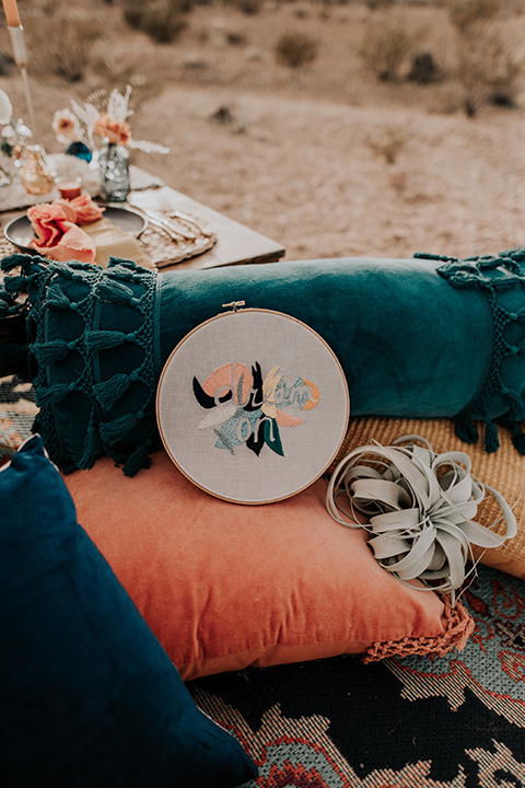  colorful pillows on the floor with a wooden table 