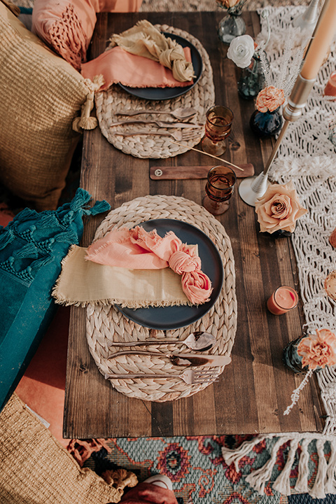  wooden table with tall candles and bohemian style table decor 