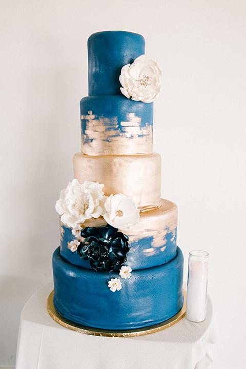  white and blue cake with gold detailing