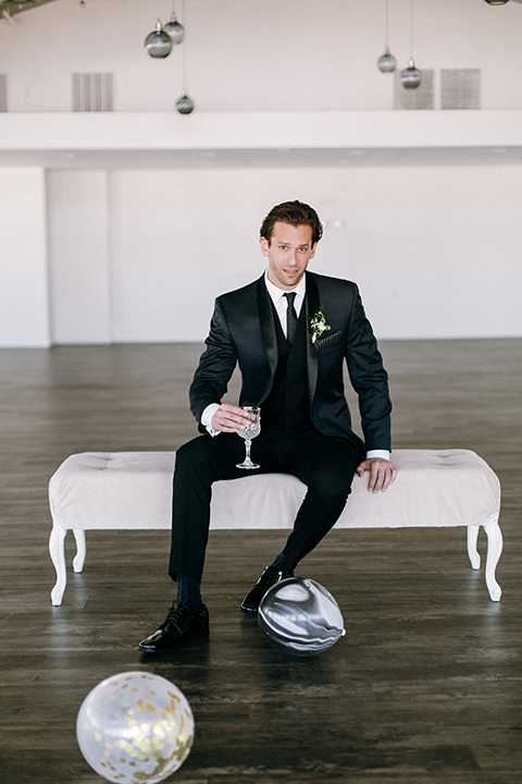  groomsmen in a navy shawl lapel tuxedo with black bow ties and white pocketsquare 