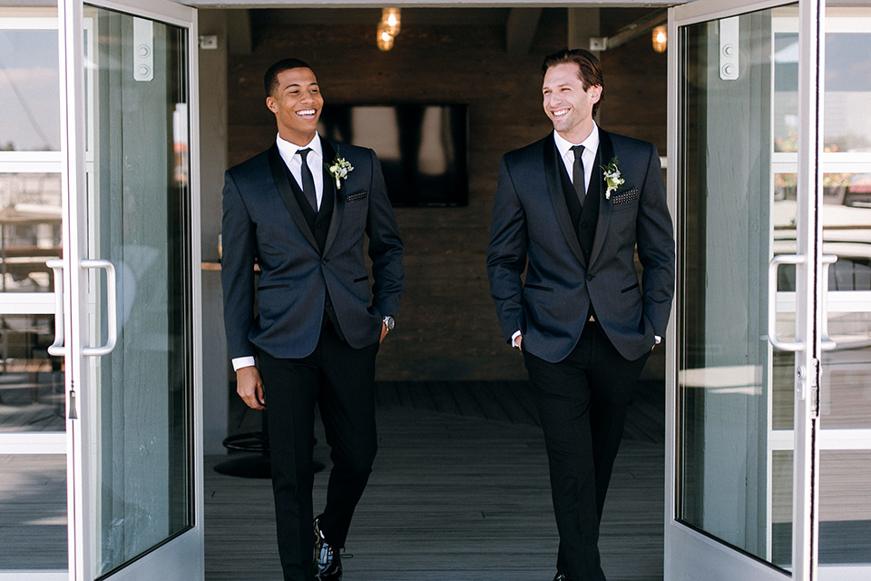  groom and groomsmen in a navy shawl lapel tuxedos with black bow ties