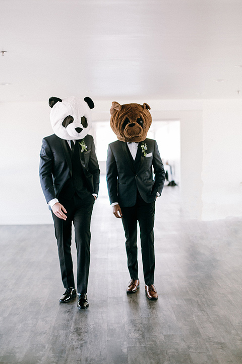  the groomsmen in a navy shawl lapel tuxedo with black bow ties