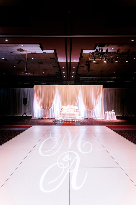  reception décor with a pink lit dancefloor and white linens