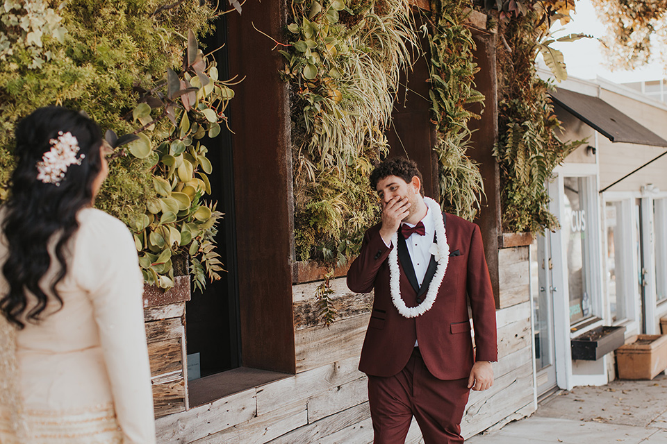  bride in a cultural Burmese gown, the groom in a burgundy tuxedo with a black shawl