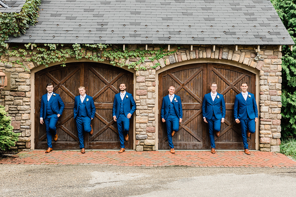  the groom in a cobalt blue suit and the groomsmen in cobalt blue suits