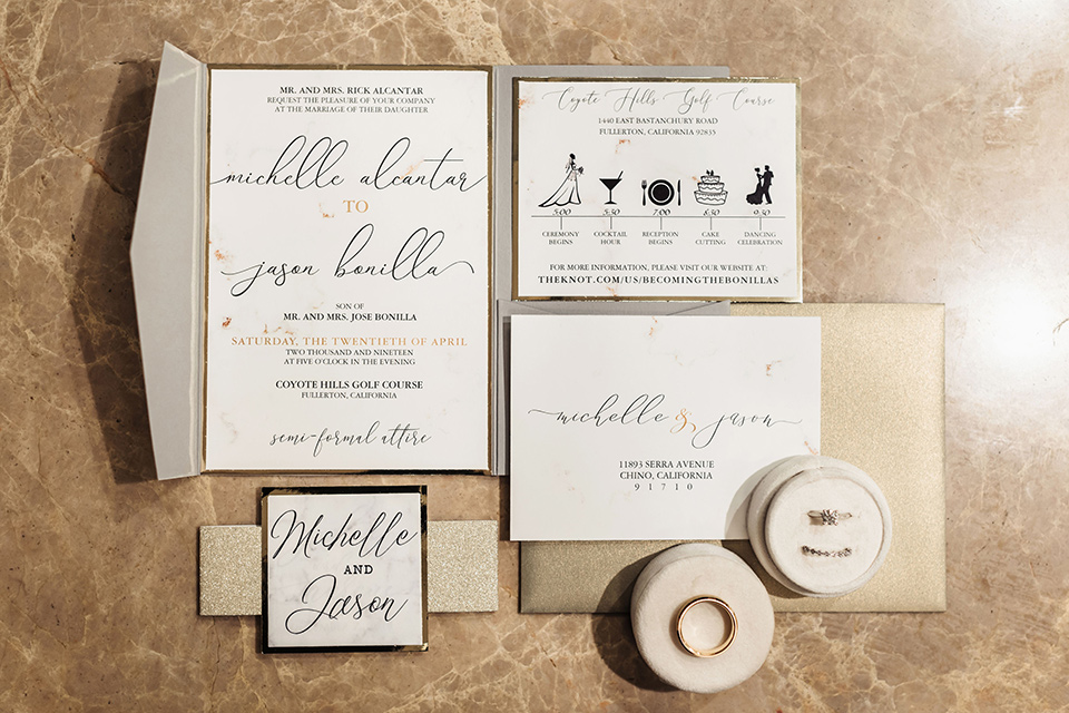  white invitations with tan and gold details 