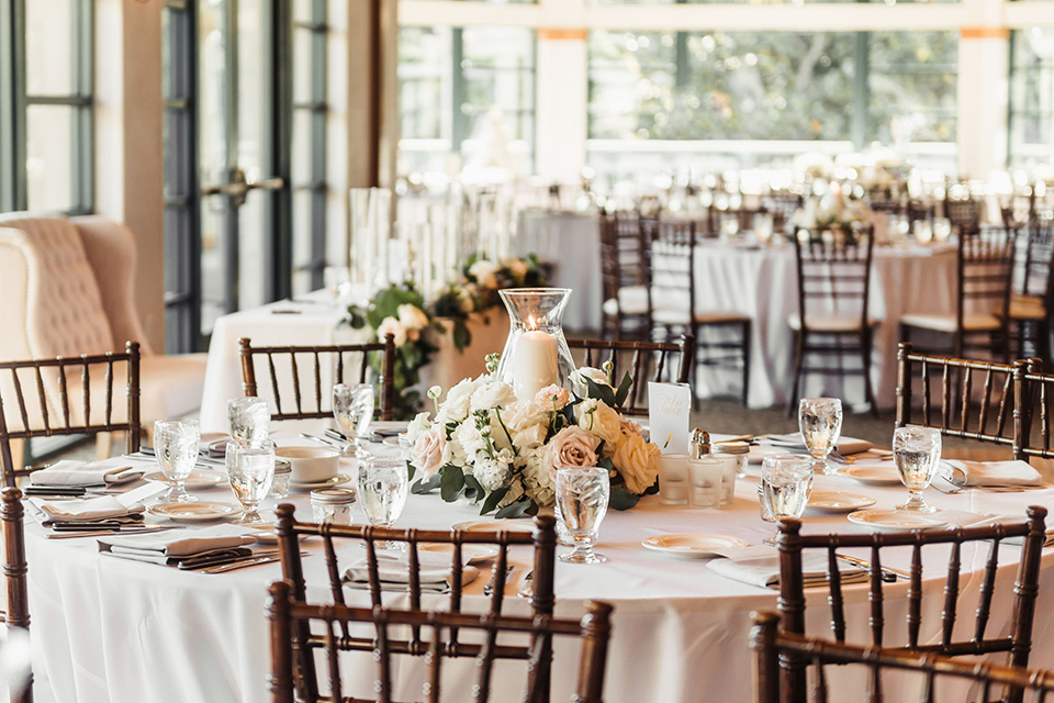  wooden table with white linens and minimalistic table decor 