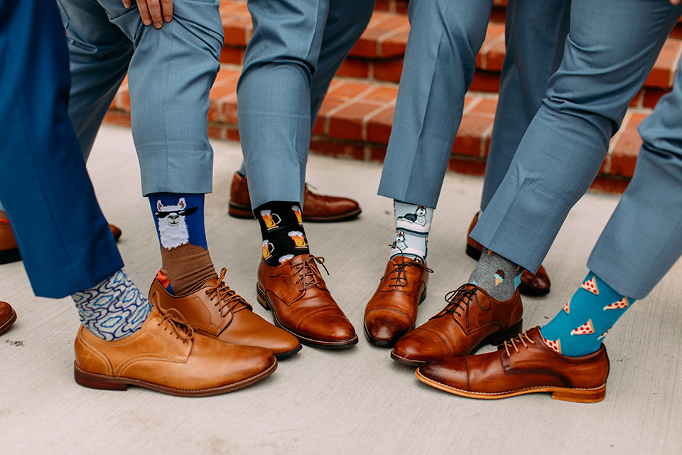  the groom in a blue suit and the groomsmen in light blue suits