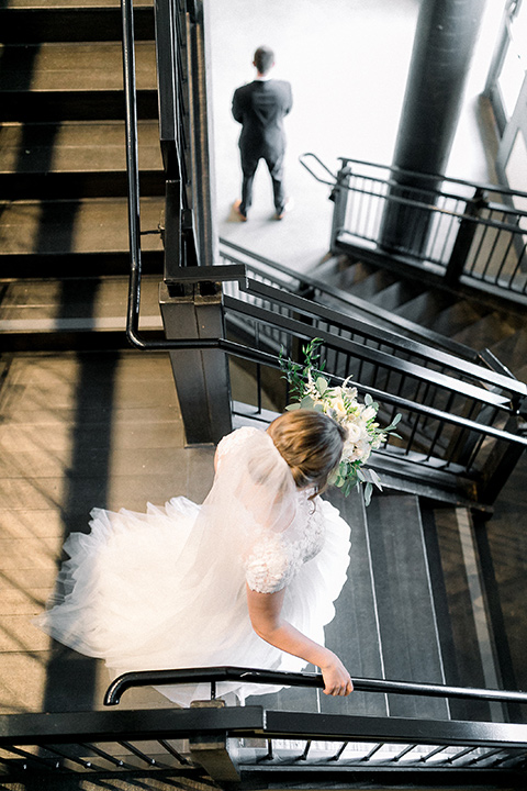  bride in a flowing gown with cap sleeves and the groom in an asphalt groom look