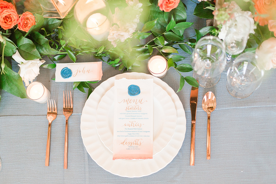 light blue table linens with white plates and gold flatware