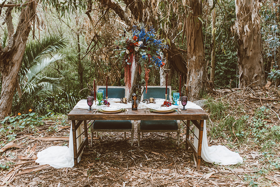  wooden tables and white flowing linens and tall candles