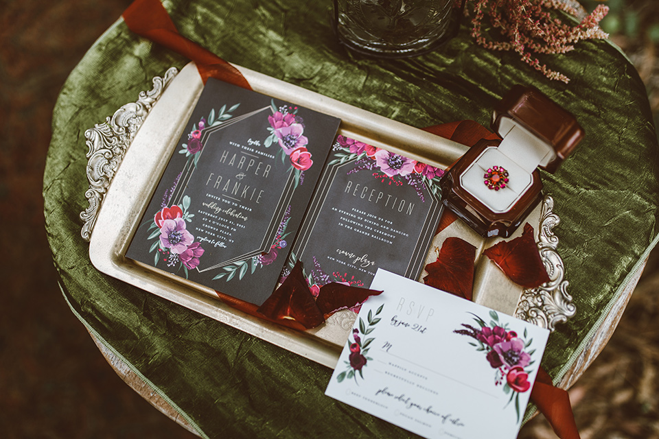  black invitations with pink rose and burgundy floral details and calligraphy