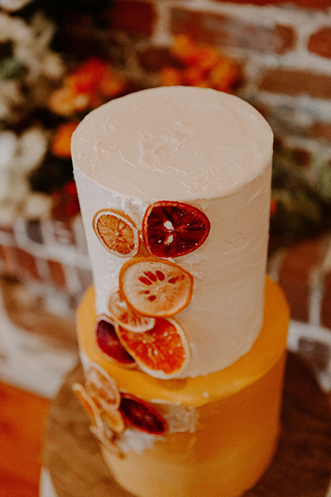  tiered cake with orange and cream detailing 