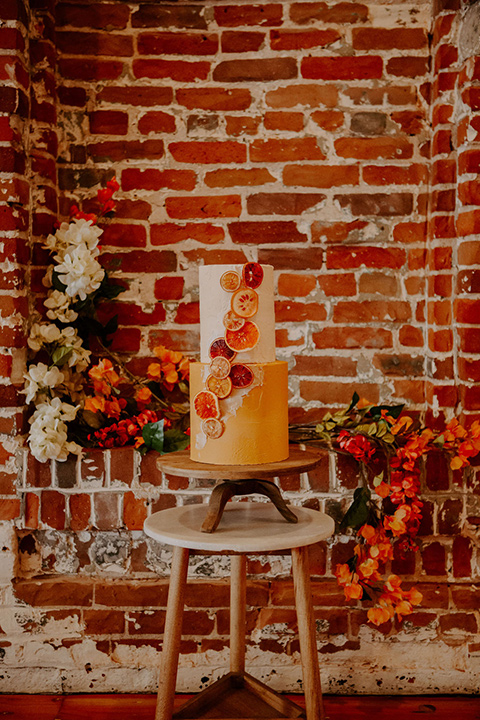  tiered cake with orange and cream detailing