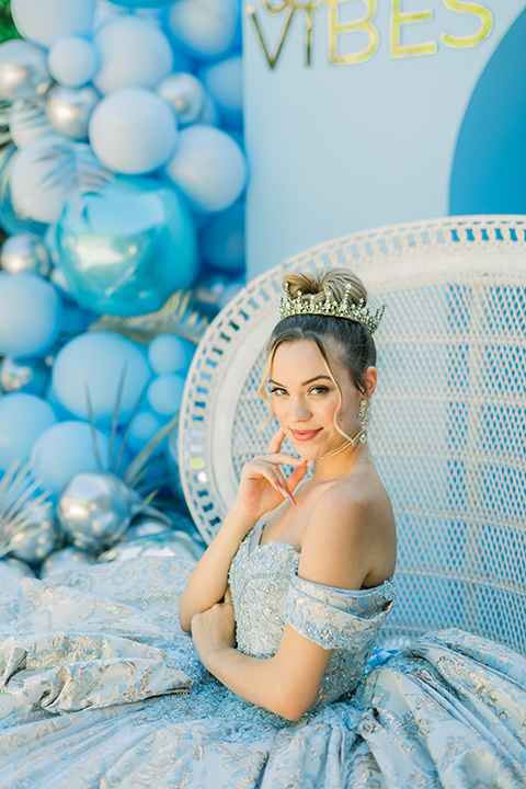  birthday girl with a light blue gown and strapless neckline