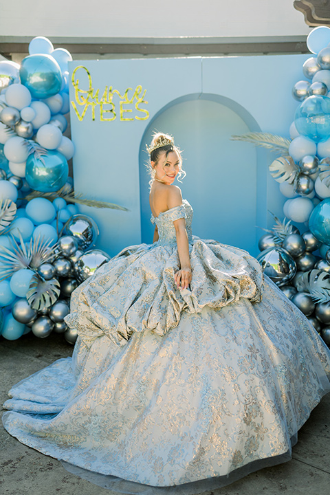  birthday girl in a light blue gown and a strapless neckline 