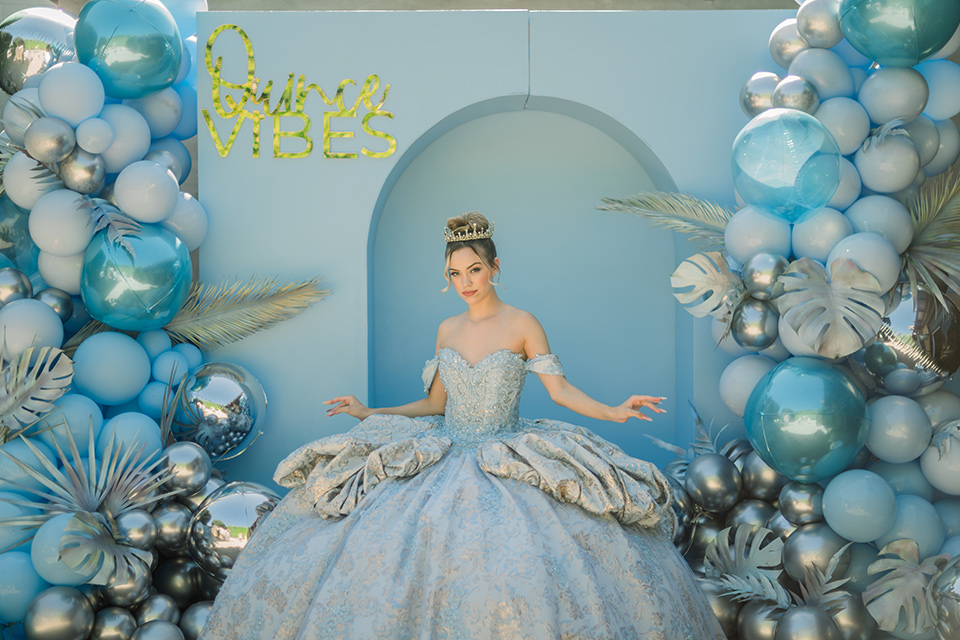  birthday girl in a light blue gown and strapless neckline 