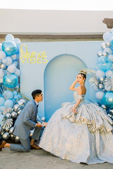  birthday girl with a light blue gown and strapless neckline and the chambelanes in a light blue suit and a dark navy tie