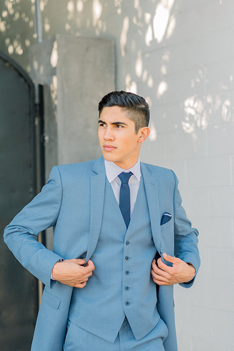  light blue suit with a navy long tie and pocket square