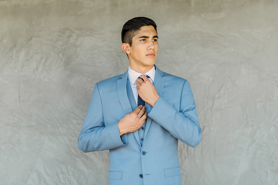  chambelan in a light blue suit and navy long tie and blue pocket square 