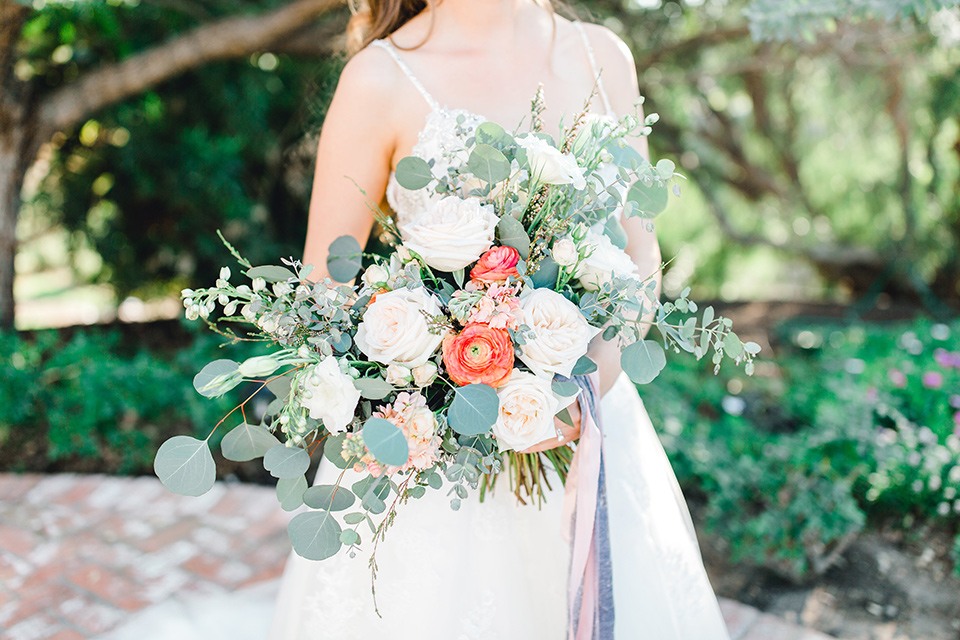 bridal bouquet with green, white, and peach flowers