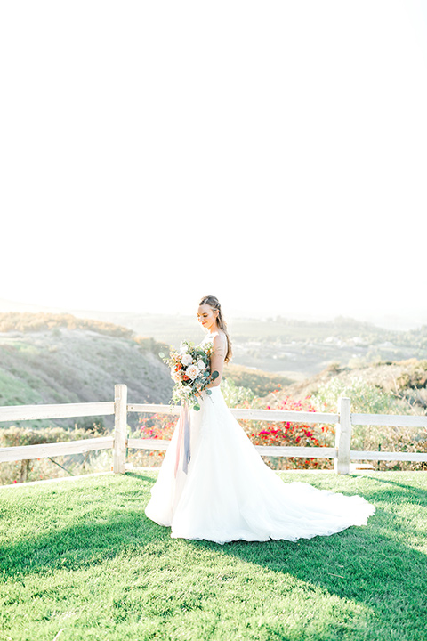  bride in a fit and flare gown with a strapless neckline and lace 