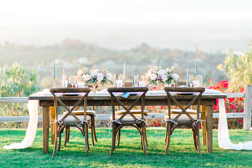  farmhouse table with white linens and white flatware