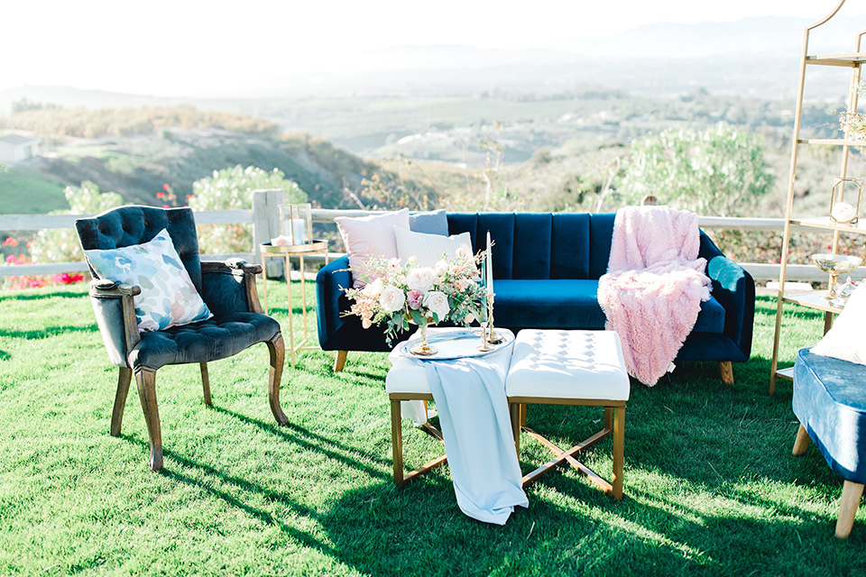 blue velvet couches and chairs with pops of pink accents