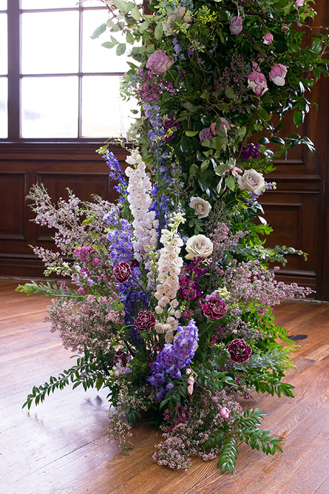  green and purple flowers on ceremony arch