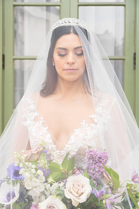  bride in a white lace ballgown with a sweetheart neckline and a regal looking crown 