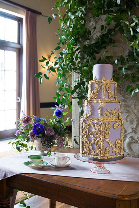  purple cake with gold detailing on a table