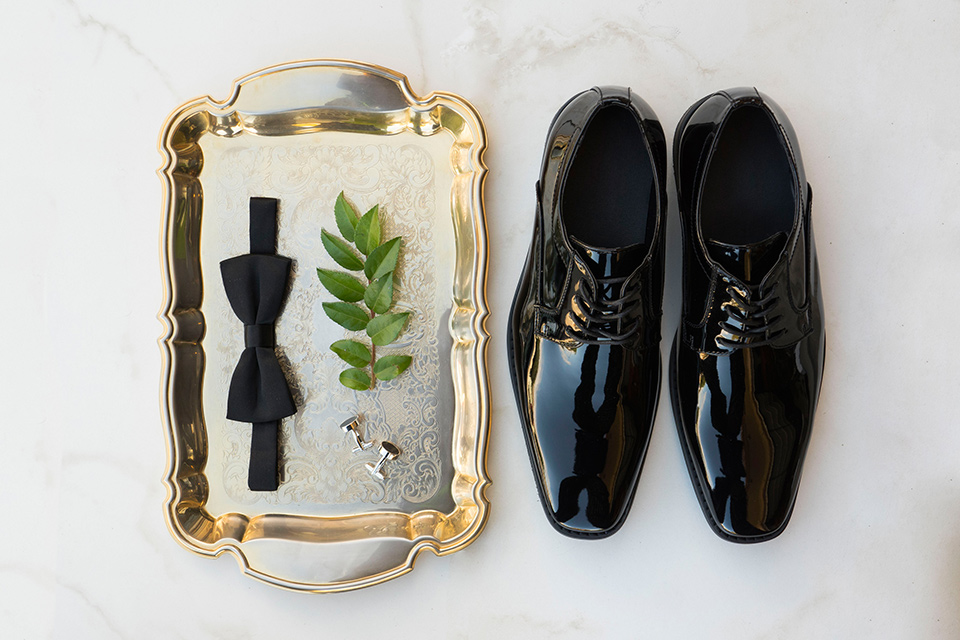  black tuxedo shoes and a gold bow tie