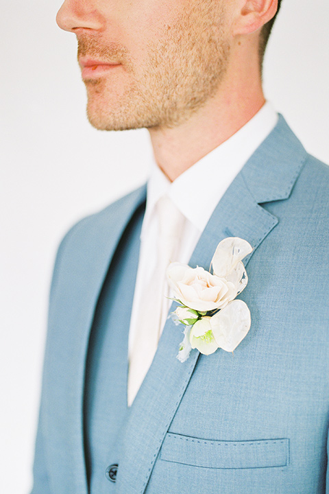  groom in a light blue suit on a boat