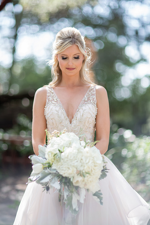  bride in a white ballgown with a deep-v neckline and crystal embellishments 