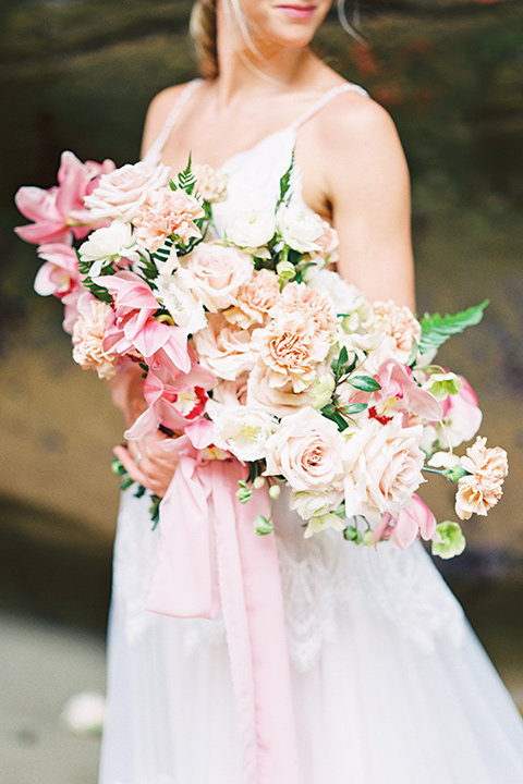  bride in a flowing blush and white gown with a silk style top 