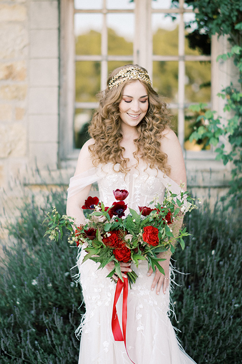  bride in a lace formfitting gown with an off the shoulder detail 