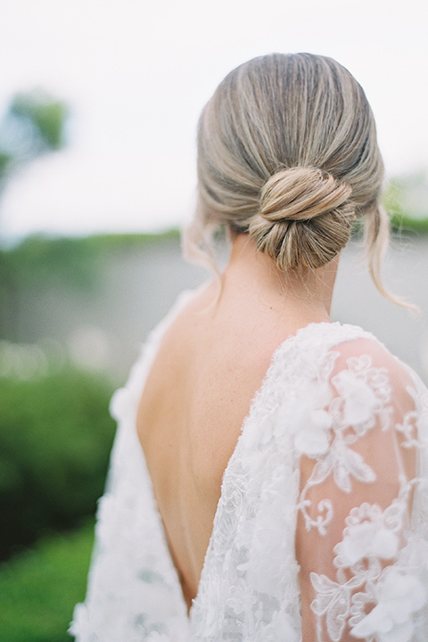  bride in a white gown with floral appliques and trumpet sleeves, the bridesmaids in black dresses in all different styles 