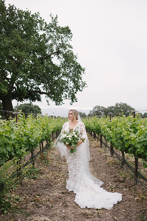  bride in a white gown with floral appliques and trumpet sleeves, the bridesmaids in black dresses in all different styles