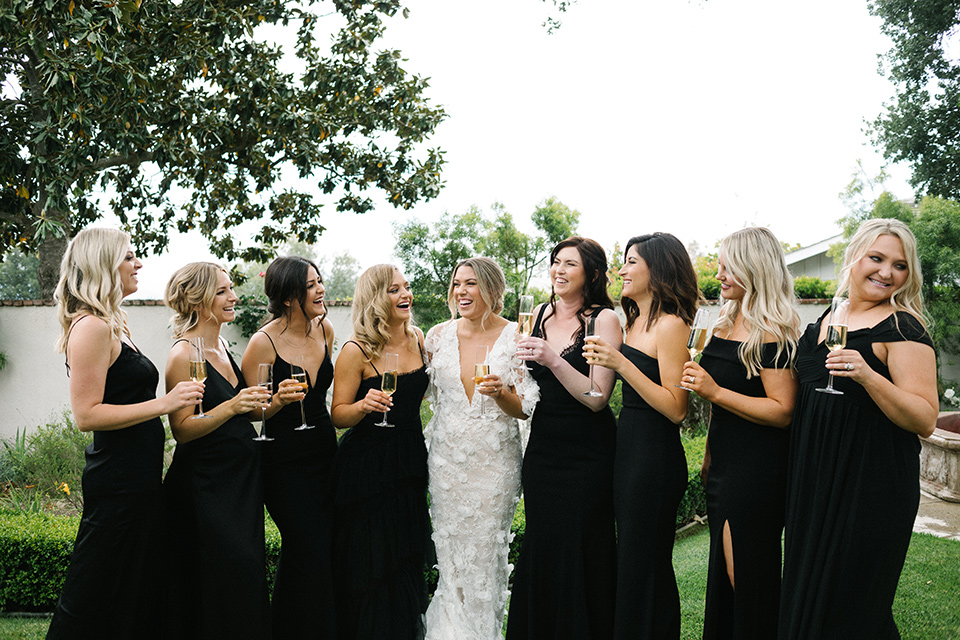  bride in a white gown with floral appliques and trumpet sleeves 