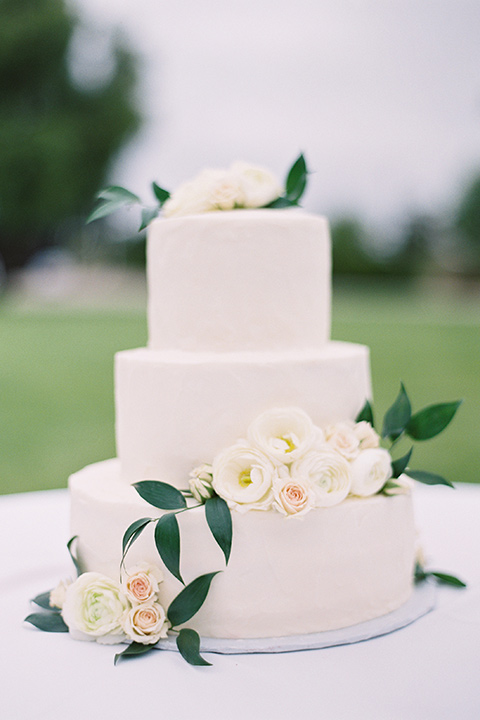  white tiered cake with white floral decor