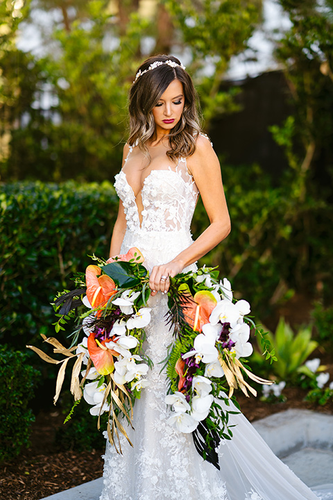  bride in a formfitting white lace gown with a sweetheart neckline and bold bouquet 